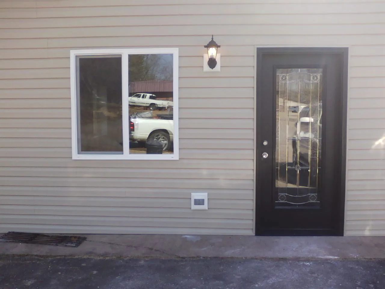 New siding, window and entry door on the side of an addition in Underwood